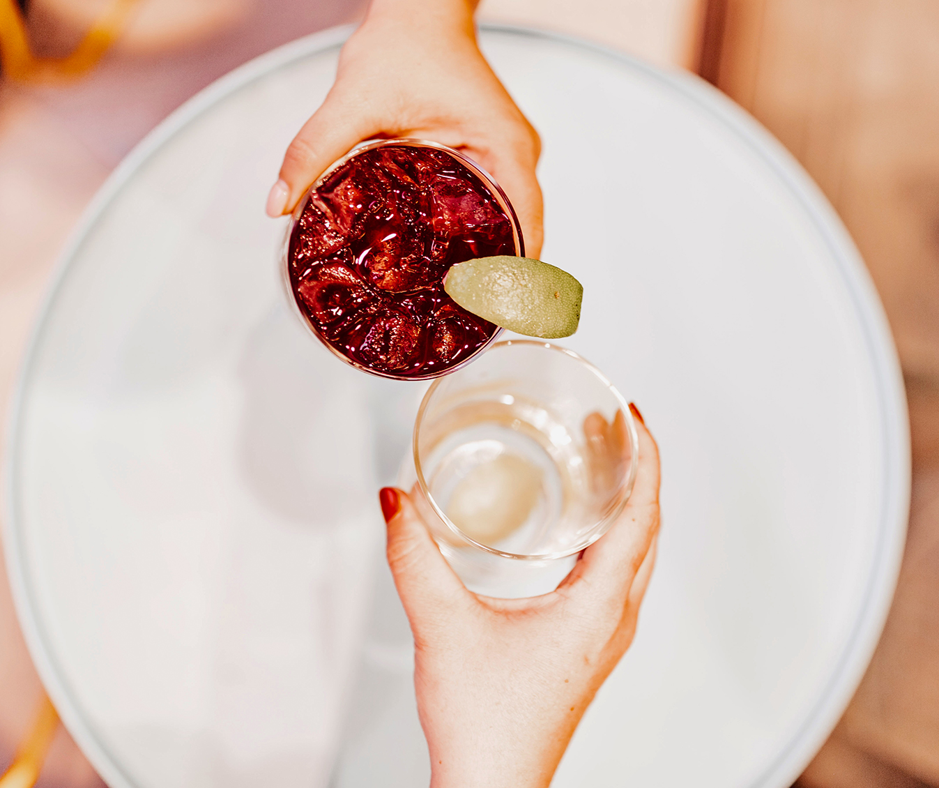 a person holding a glass with a drink