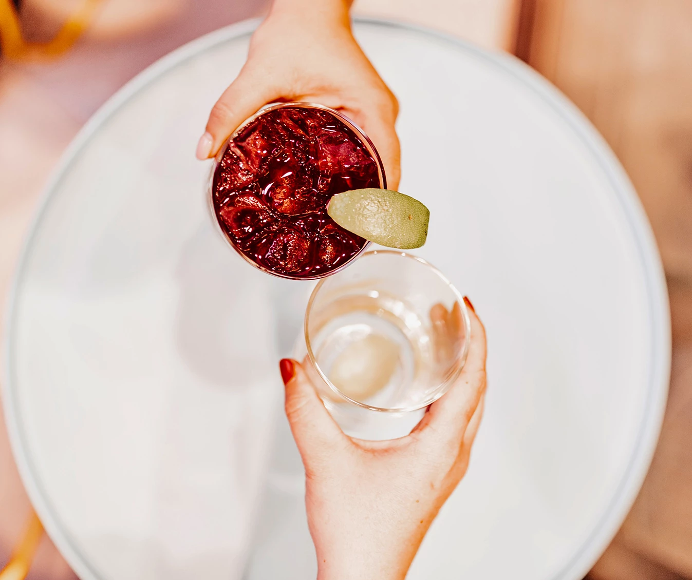 a person holding a glass with a drink