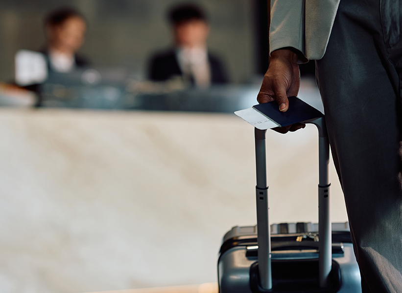 a person holding a passport and luggage