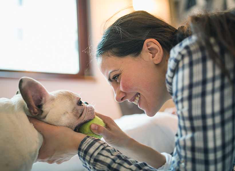 a woman holding a tennis ball and smiling