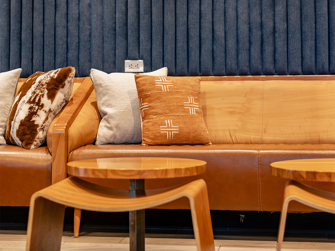 a couch with pillows and a table