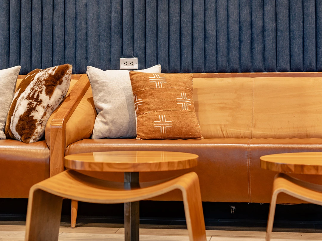 a couch with pillows and a table