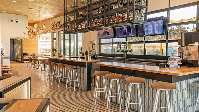 a bar with stools and shelves