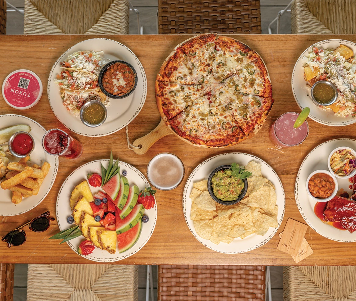 a table with plates of food and drinks