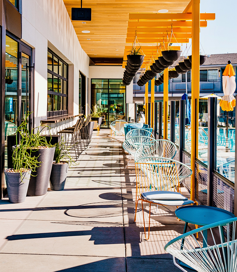a patio with chairs and tables