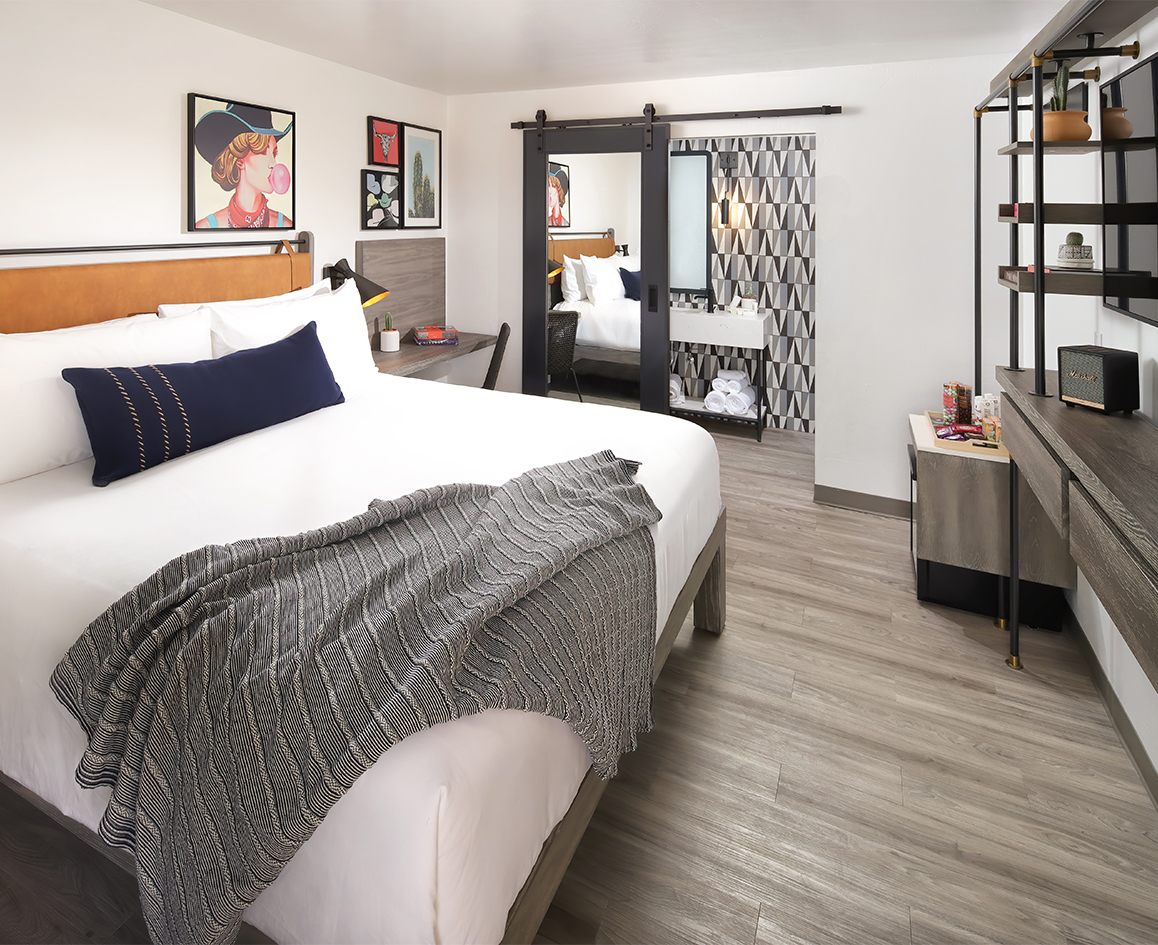 a bedroom with a bed and a mirror