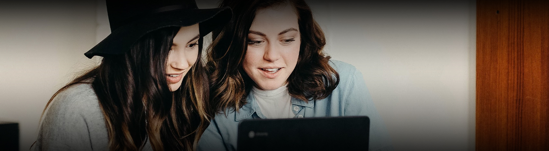 a woman looking at a laptop