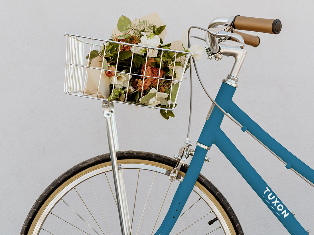 a blue bicycle with a basket of flowers