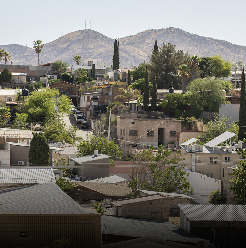 a city with trees and mountains in the background