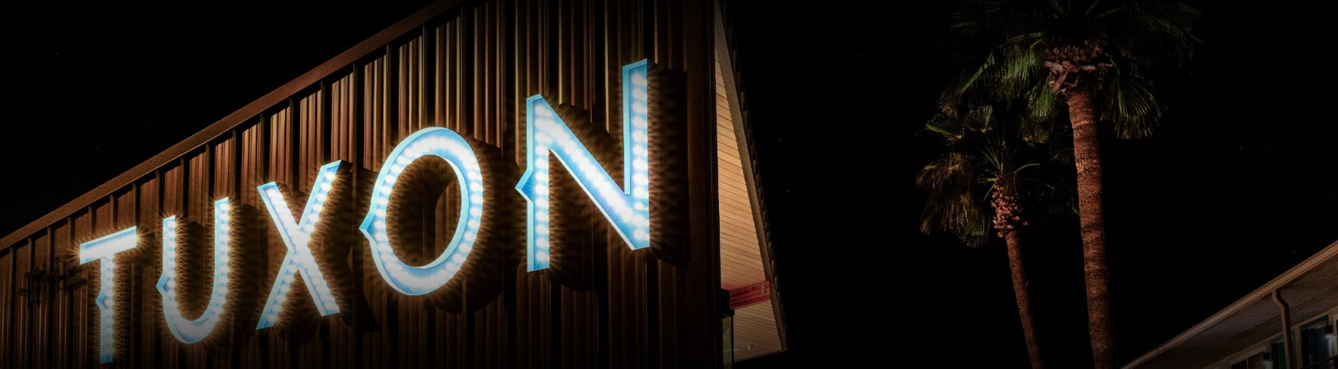 a lit up blue letter on a building