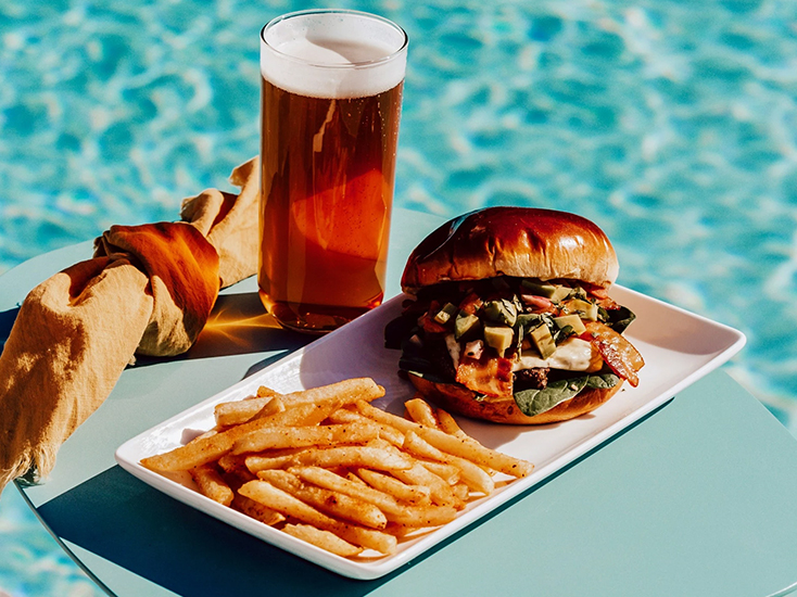 a plate of food and a glass of beer next to a plate of food