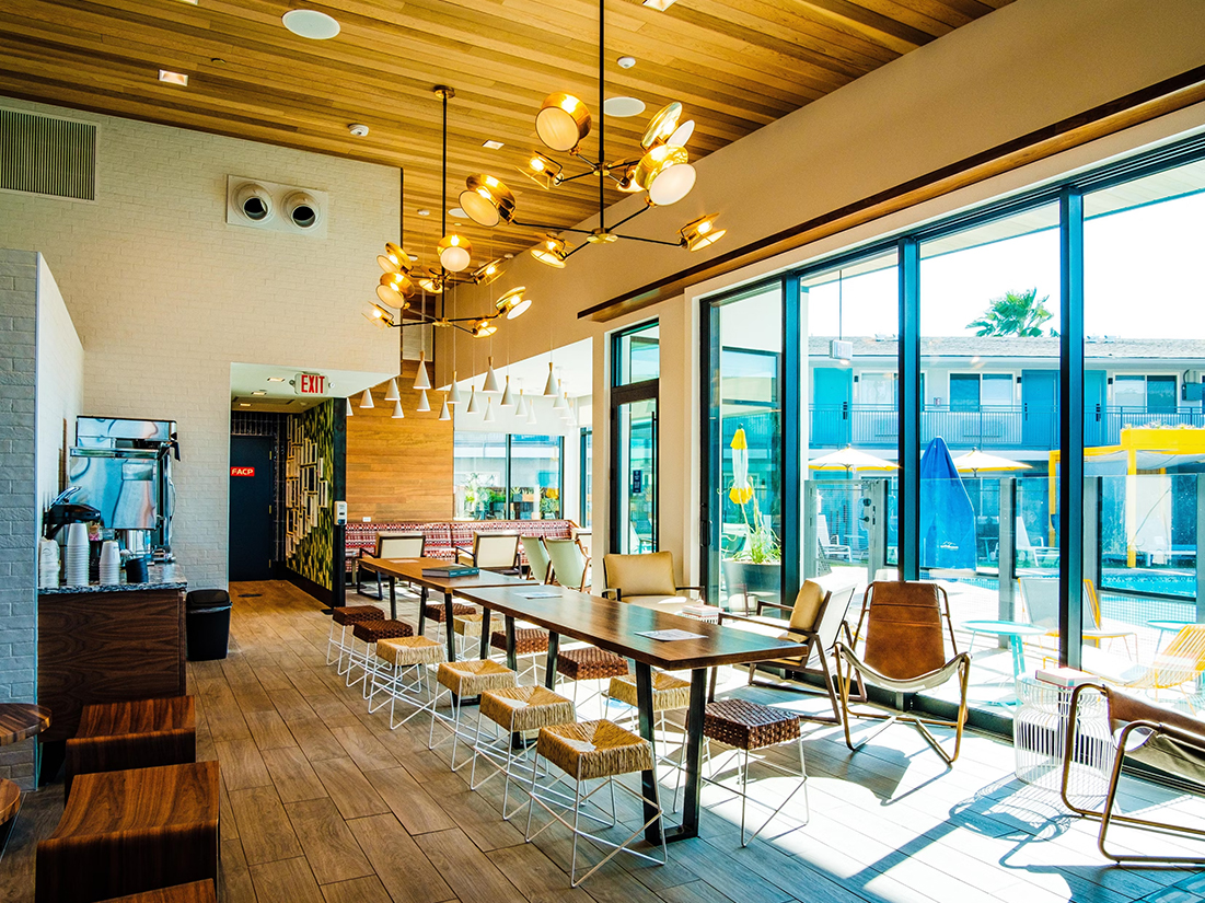 a room with a long table and chairs
