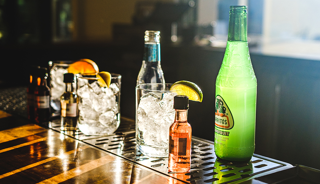 a group of bottles and glasses on a bar