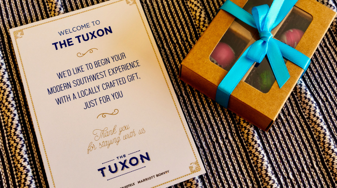 a card and a box with a blue ribbon