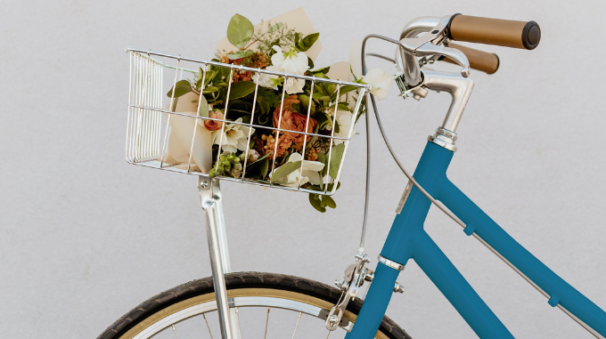 a basket of flowers on a bicycle