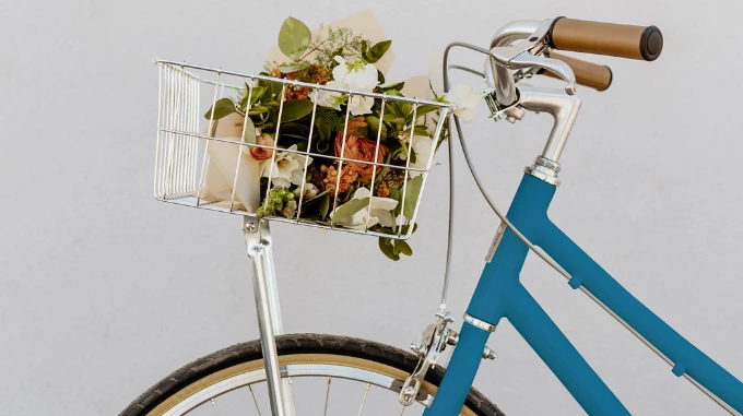 a basket of flowers on a bicycle