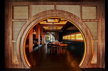 a circular doorway with a table and chairs