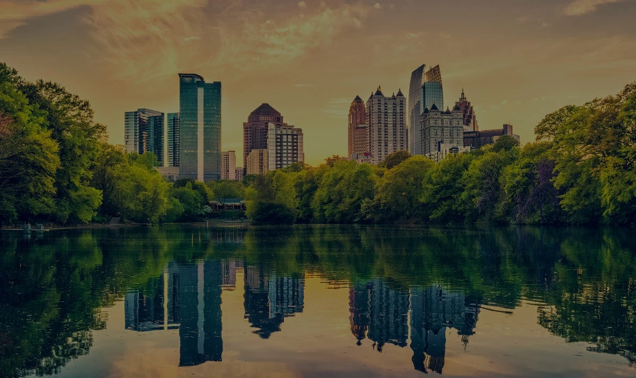 Large pond with a view of downtown in the background at sunset