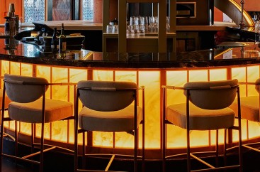 a bar with chairs and a counter