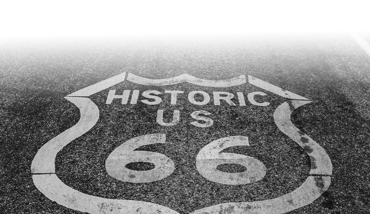a close-up of a road with a sign