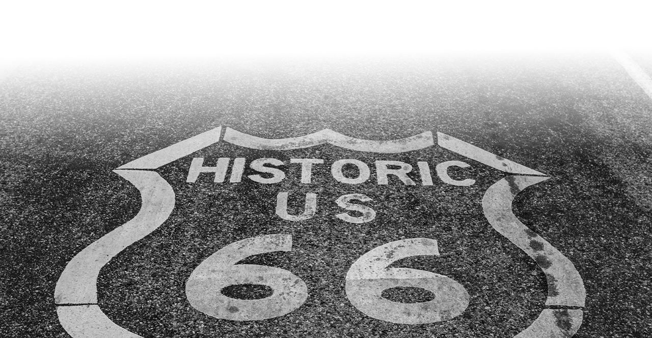 a black and withe road with a sign on it