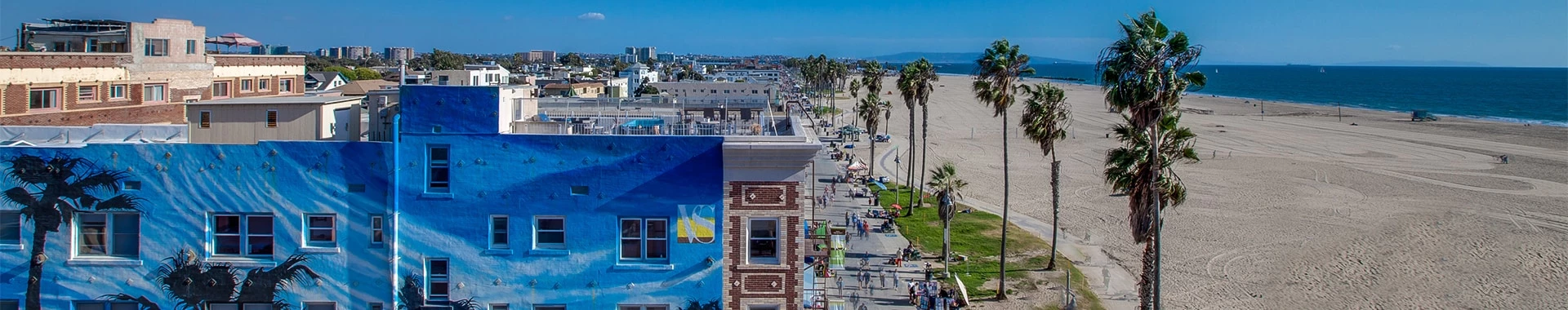 a beach with buildings and trees