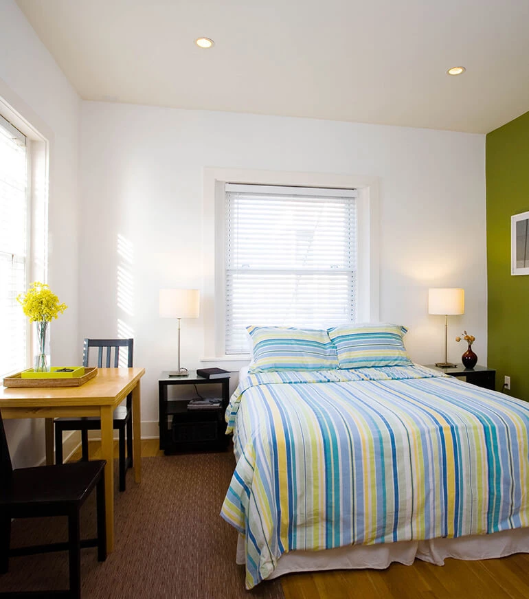 a bedroom with a bed and desk