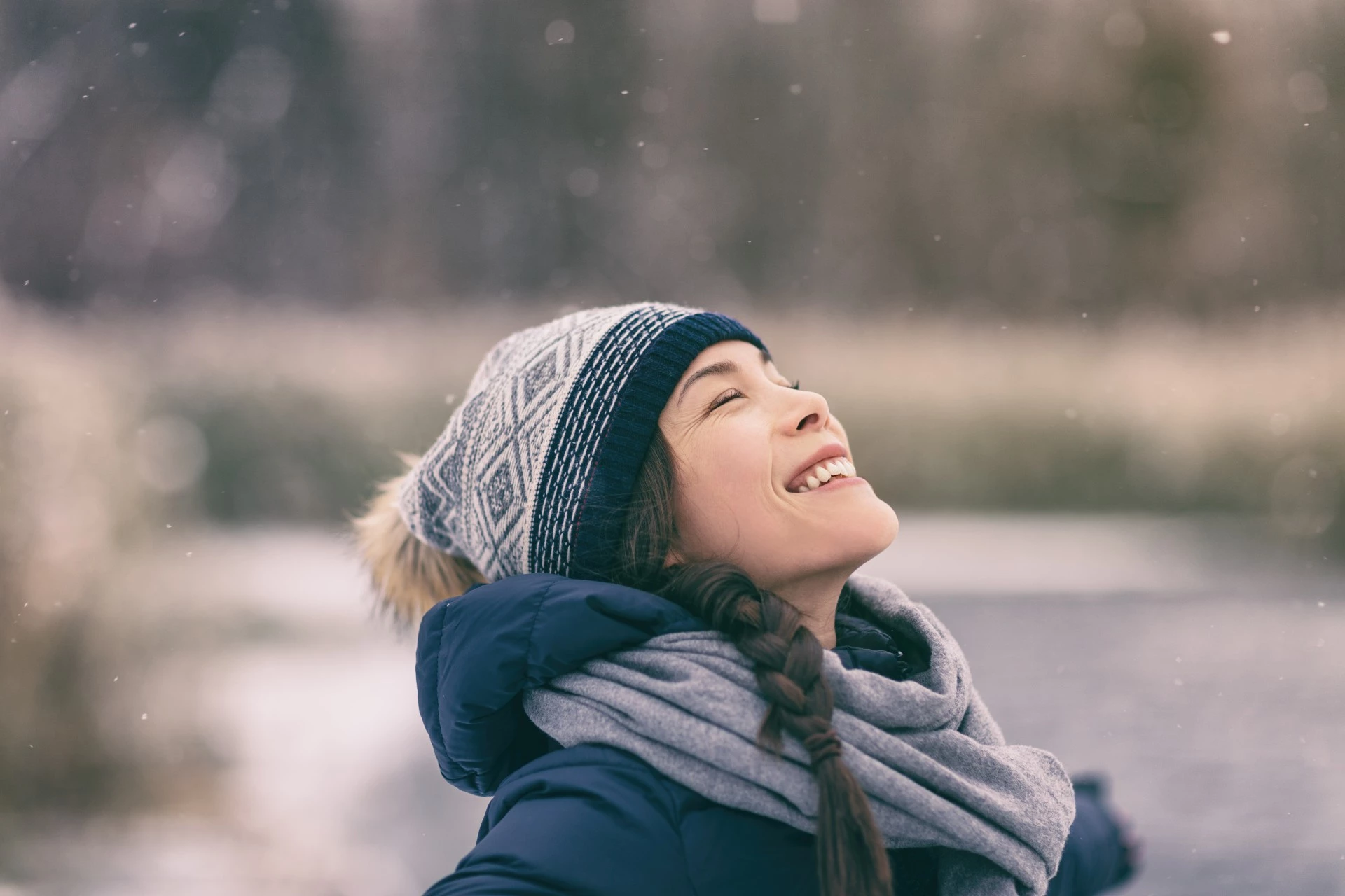 a woman in a hat and scarf smiling