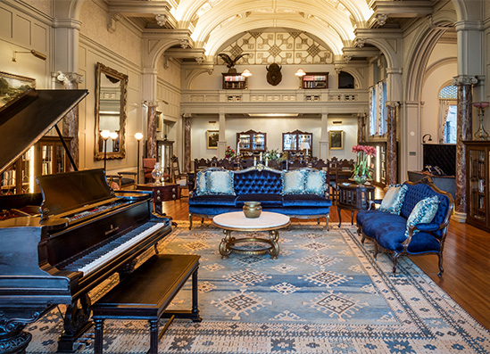 a room with a piano and couches