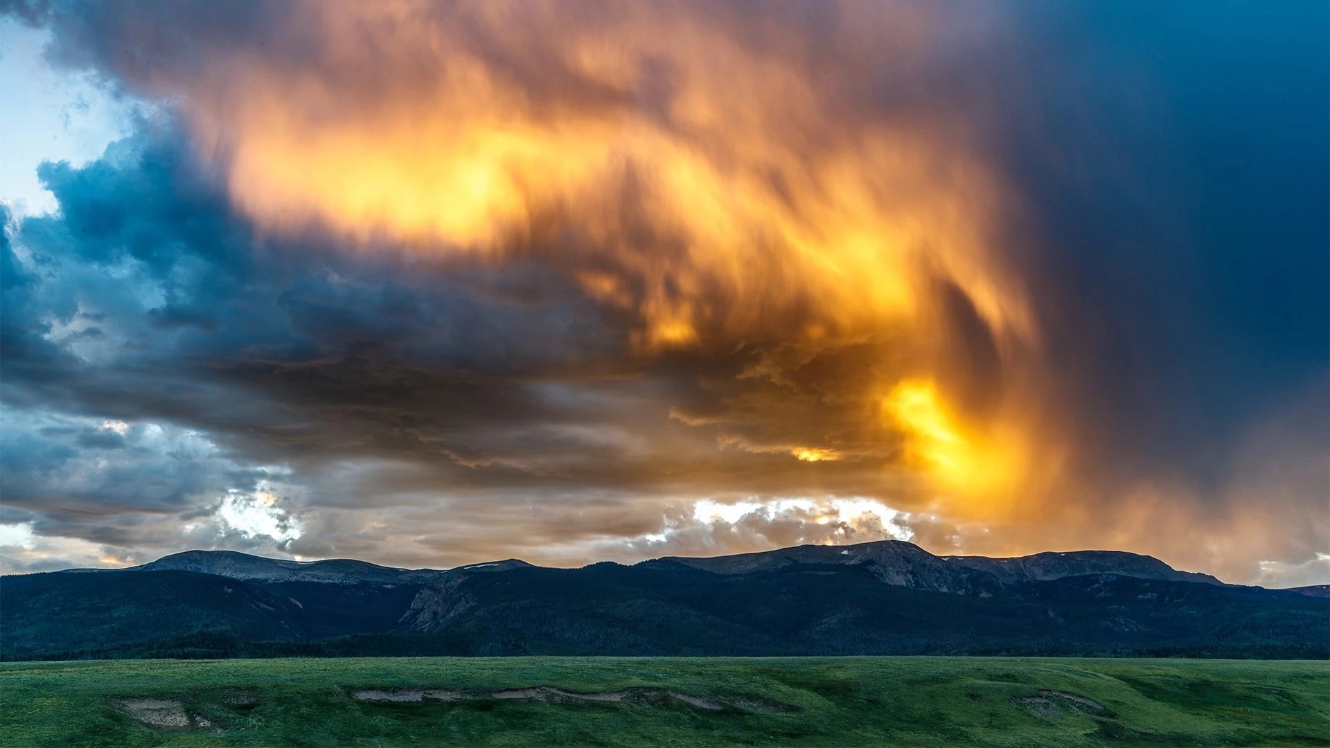 a sunset over a mountain range