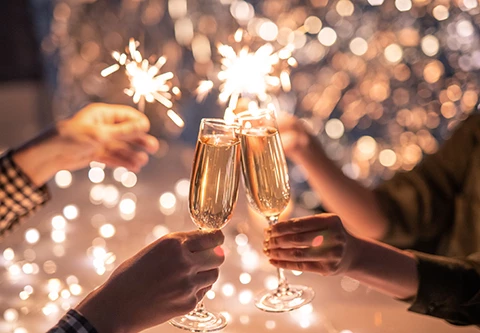 a pair of hands holding champagne glasses