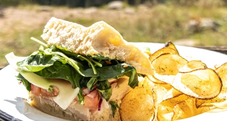 a sandwich and potato chips on a plate