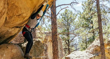 a woman climbing a rock