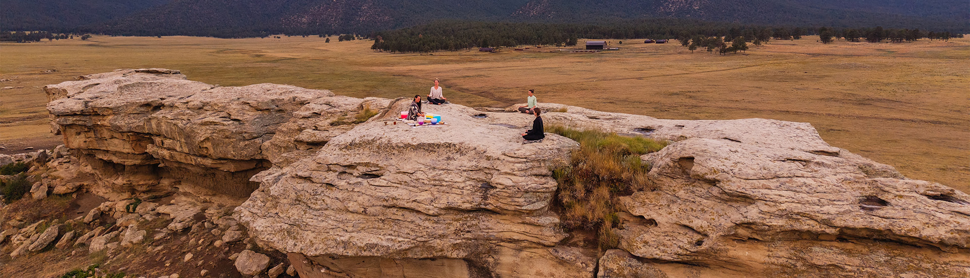 a group of people sitting on a rock