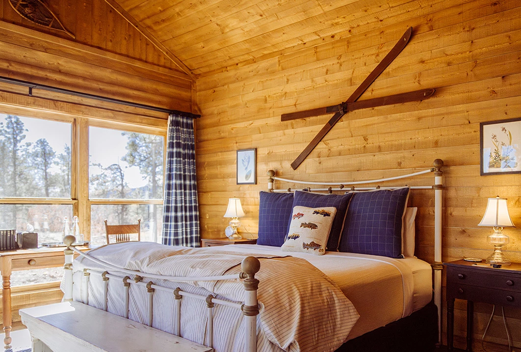 a bed in a log cabin