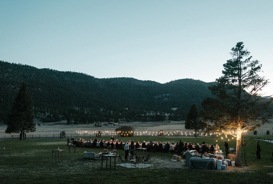 a group of people standing in a field with a large group of people standing in a field