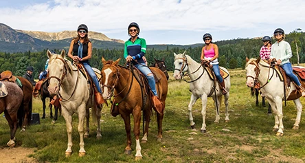 a group of women riding horses