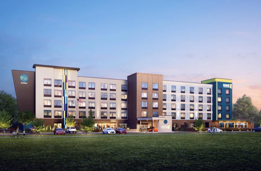 a building with many windows and cars parked outside