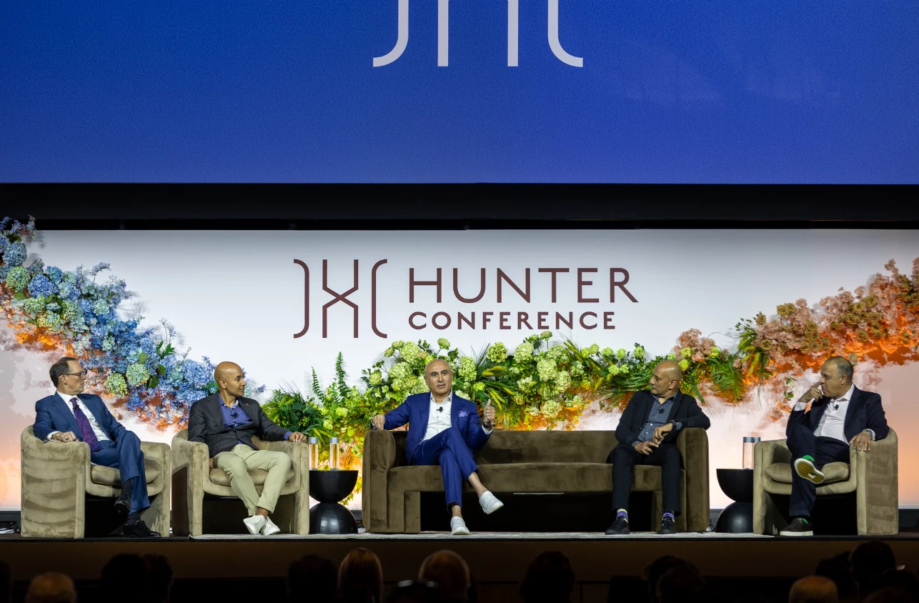 a group of men sitting on a stage