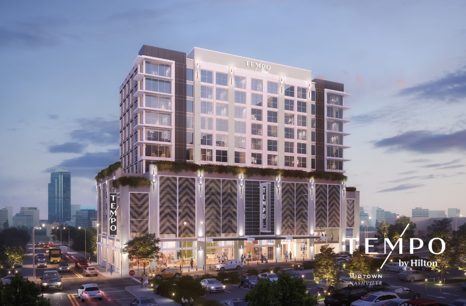 a building with many windows and a parking lot in the background