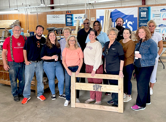 group of people posing in a garage
