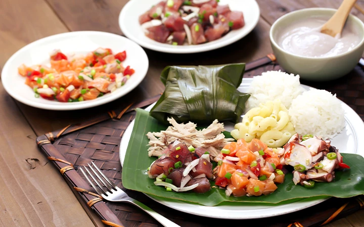 A table with several plates of food, including a plate with rice, meat, and vegetables.