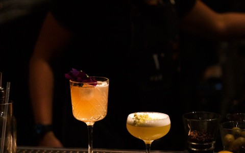 a group of drinks on a bar