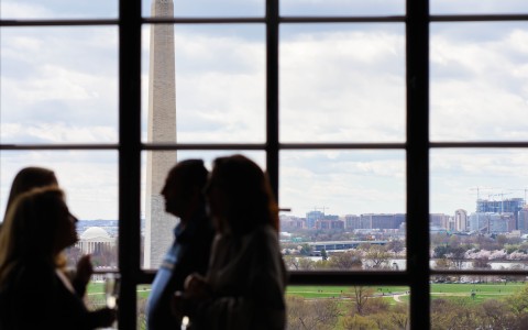 a group of people looking at a tall monument