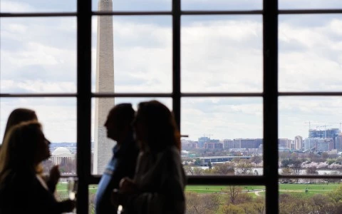 a group of people looking at a tall monument
