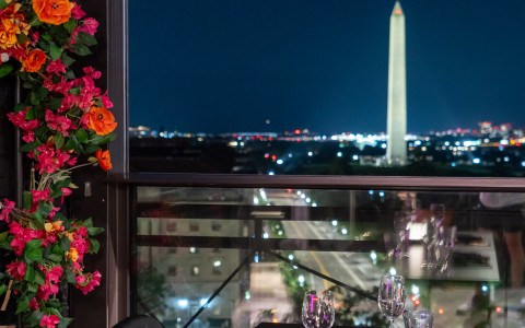 a table with flowers and a tower in the background