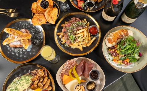 a table with plates of food and drinks
