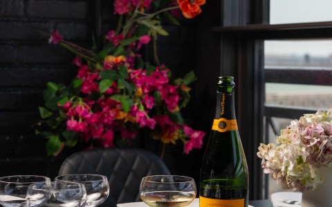 a wine bottle and glasses on a table
