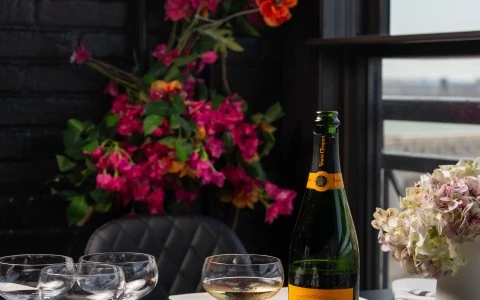 a wine bottle and glasses on a table