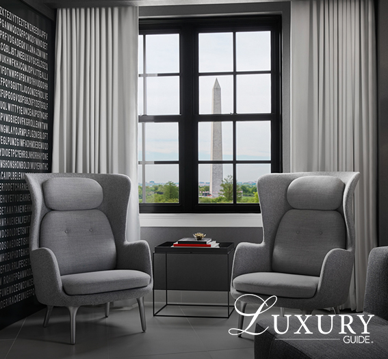 a room with grey chairs and a table